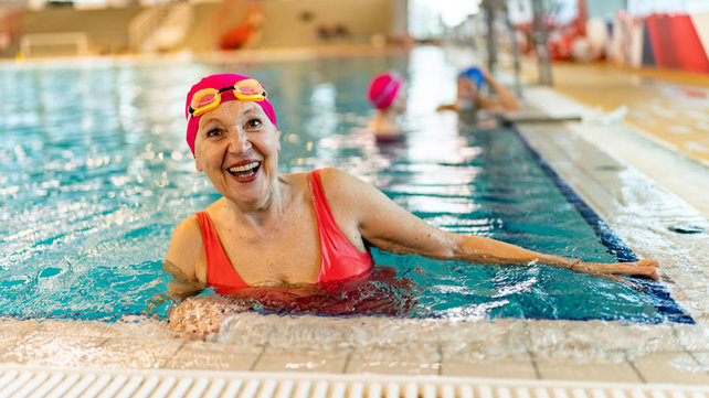 Senior women in pool smiling