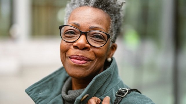 Older woman smiling at the camera.