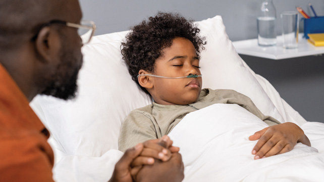 Child laying in a hospital bed