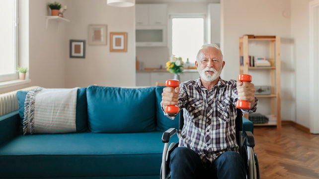 man sitting on chair lifting weights