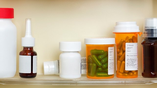 Pill bottles and medications in a bathroom cabinet