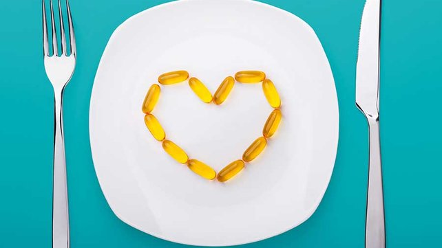 Plate with fish oil supplements shaped as a heart