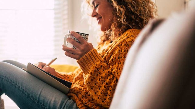 Women sitting on couch with tea