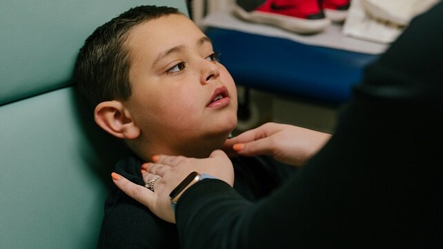 Young boy receiving a health exam