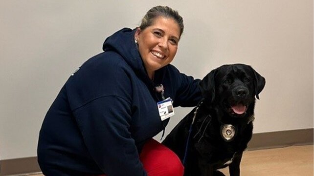 Employee at Morton Hospital with a therapy dog