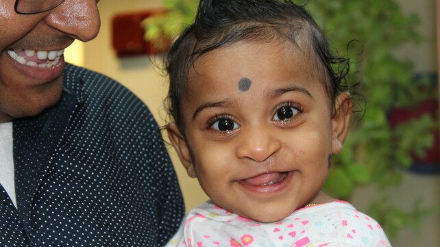 Photo of a young South Asian child smiling