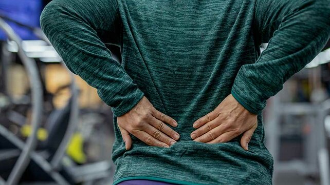 Women holding lower back from pain