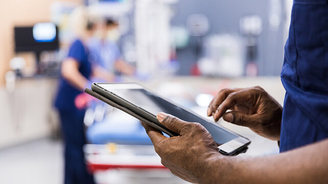 Nurse reading medical information on a tablet