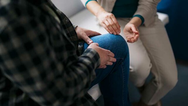 Orthopedic doctor looking at patient's knee