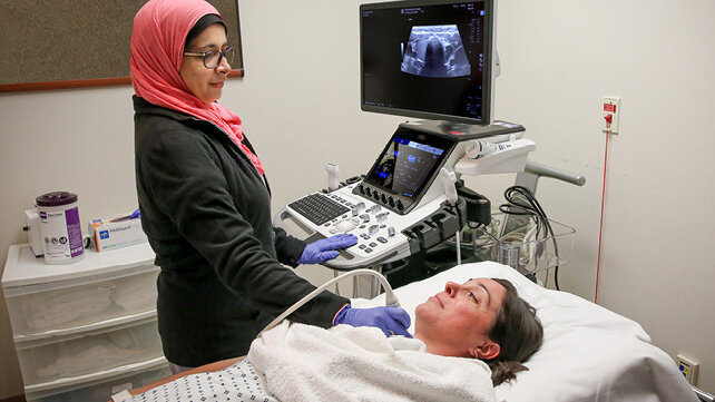 A clinician performs Diagnostic Medical Sonography on a patient.