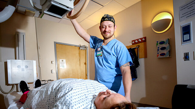 A clinician administering a Radiography (RAD).