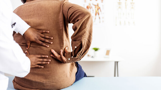 Person with disc pain at doctor's office