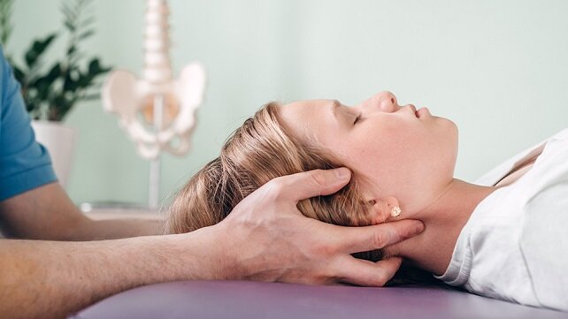 A woman receiving craniosacral therapy