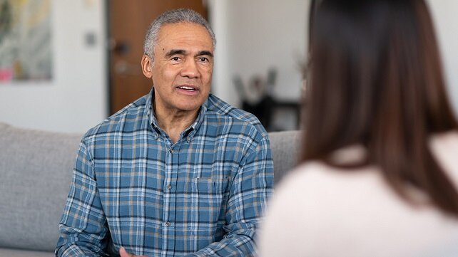 Older adult male speaking with a behavioral health specialist