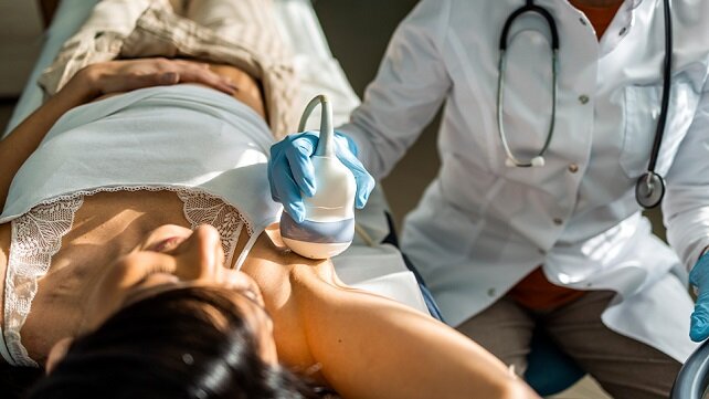 Adult female getting a breast exam.