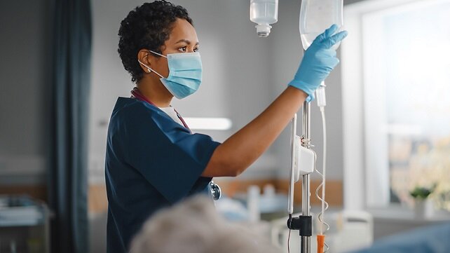 Emergency room nurse preparing fluids for a patient.