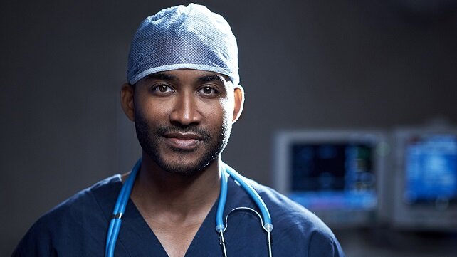 Male surgeon in scrubs looking at the camera