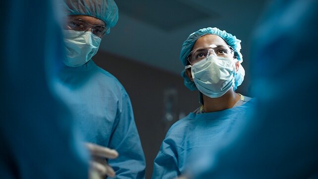Surgeons in the operating room preparing for a surgery.