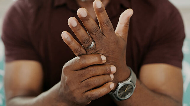 Man with arthritis massaging hands