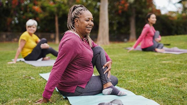 Women doing yoga in park