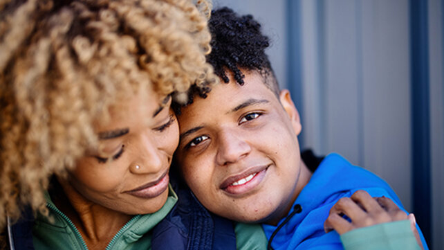 mom hugging school-age son