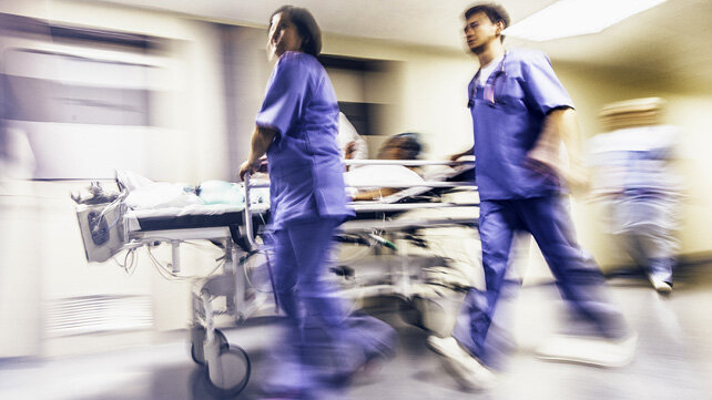 Patient being rushed on a srtetcher through emergency services 