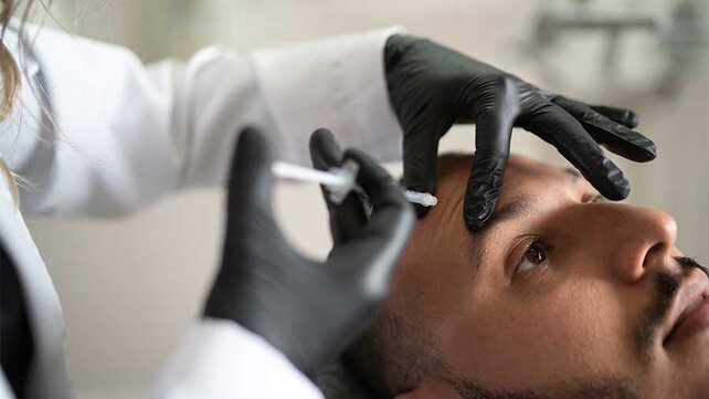 Man receiving botox injection in forehead