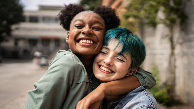 Two friends hug each other.