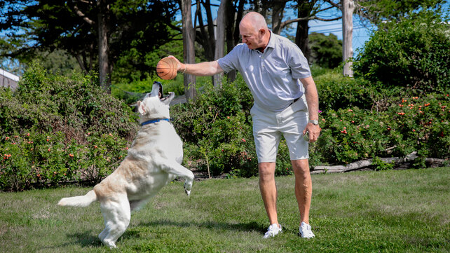Patient Tom Cioffi plays with his dogs