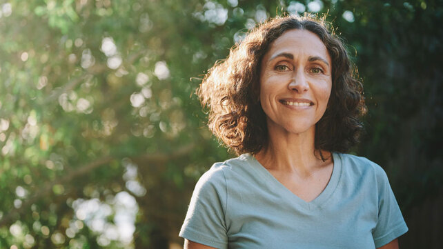 Women in 50s smiling outside