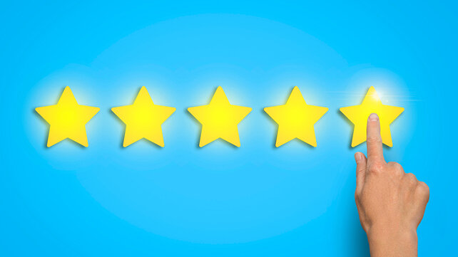 Graphic of five gold stars with a hand pointing at the fifth star