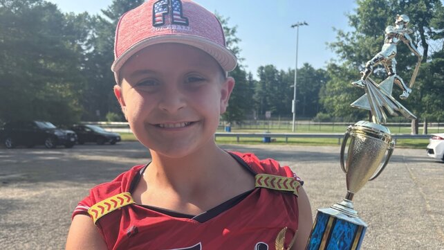 Emily Almeida holds a trophy.