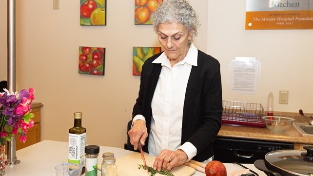 Jeanette Nessett, from the Brown University Health Community Health Institute, showing demonstrating healthy cooking in their test kitchen.