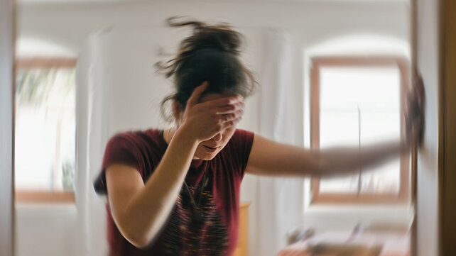 Women dizzy after standing up with hand on head