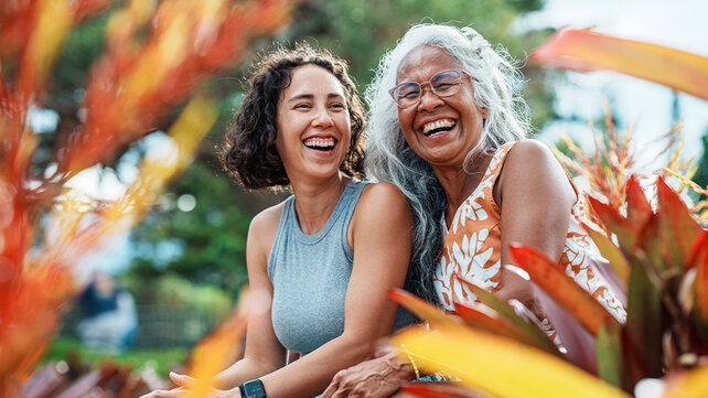 Two women smile at the camera.