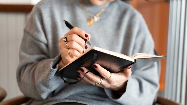 Women writing in notebook