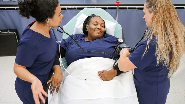 Nursing assistant training program students practicing.