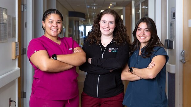 Three female nurses at Newport Hospital, smiling at the camera.