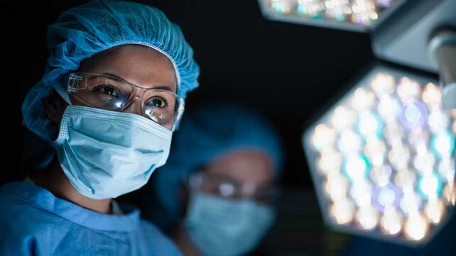 Female surgeon with medical mask