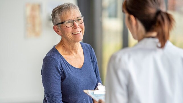 A woman receiving a medical consultation from a female doctor