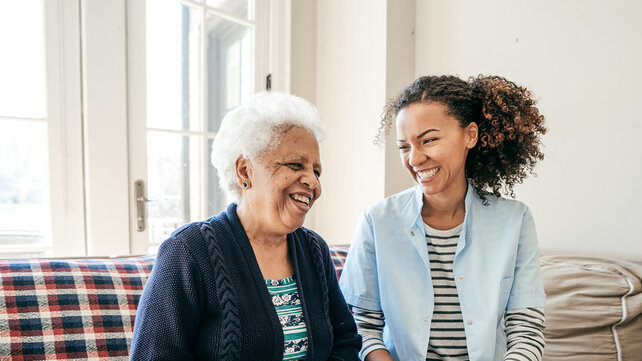 old and young women sitting and laughing