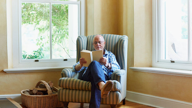 older man reading at home