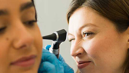 Ear Nose and Throat Specialist examining a patient